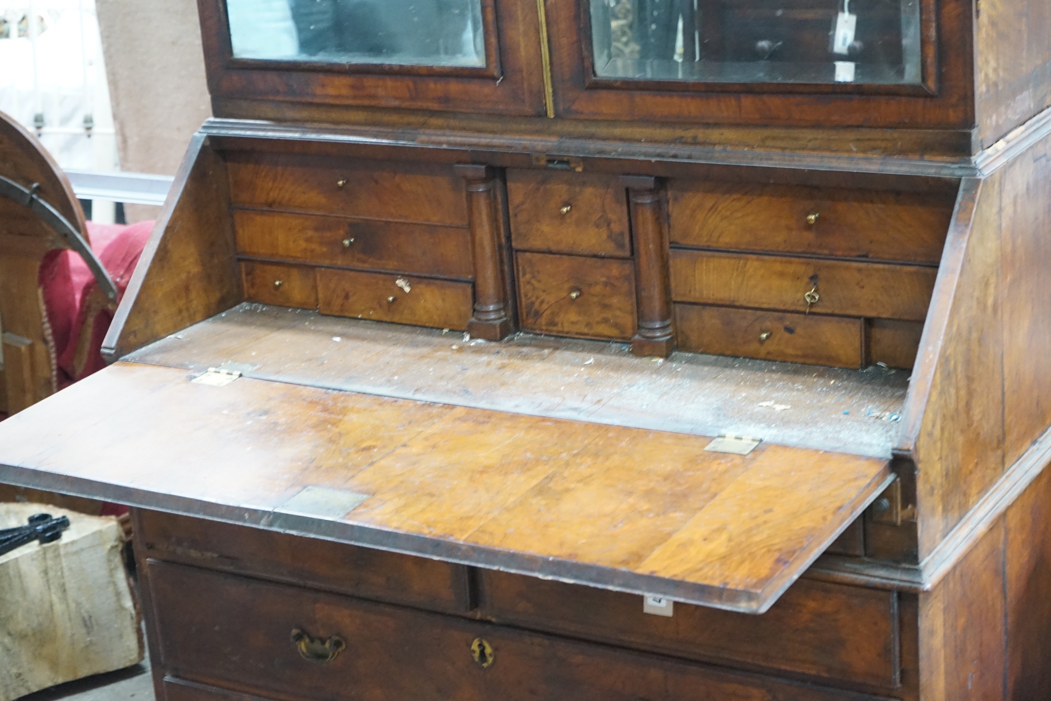 A mid 18th century feather banded figured walnut bureau cabinet, width 111cm, depth 57cm, height 207cm